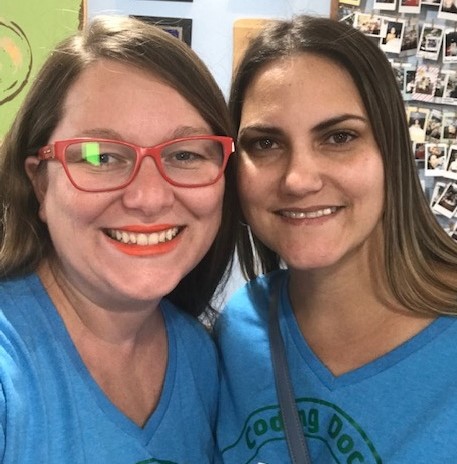 Two female Code Club leaders smiling  in blue T-shirts. 